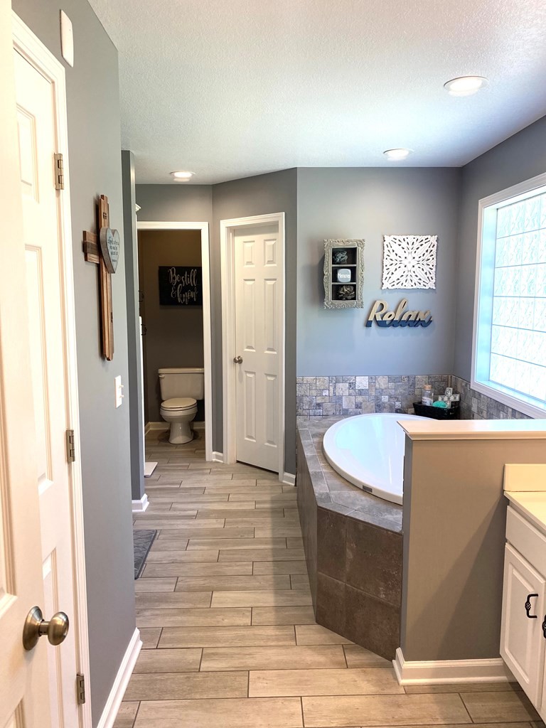 210 Clarks Store Sinking Fork Road Cerulean, KY 42215 - Photo 24 of 45 a view of a bathroom with a tub sink and mirror