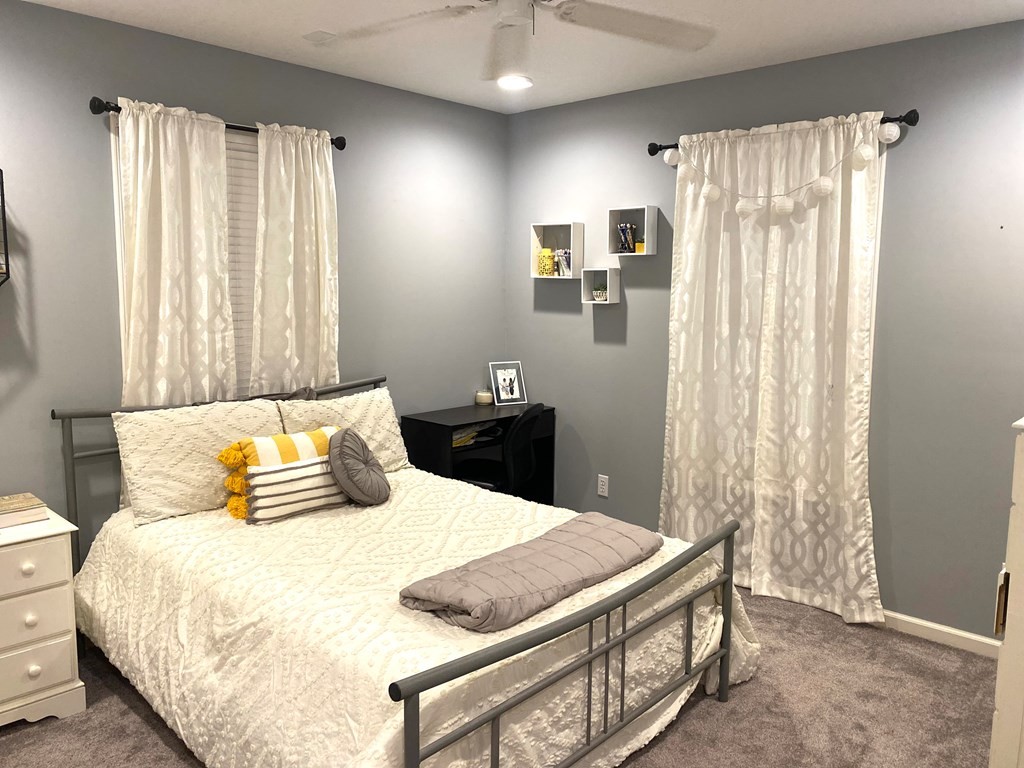 210 Clarks Store Sinking Fork Road Cerulean, KY 42215 - Photo 36 of 45 a bedroom with a large bed and a chandelier