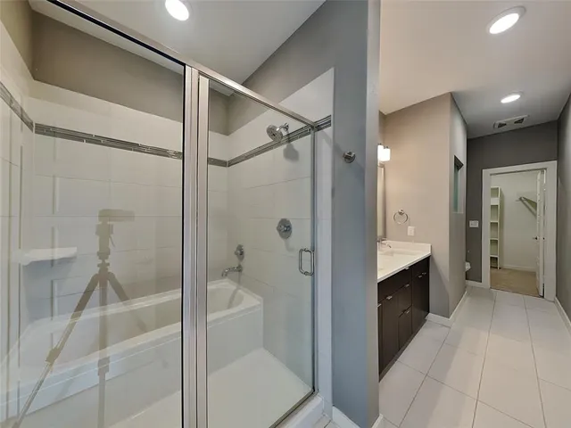 a bathroom with a shower and a sink
