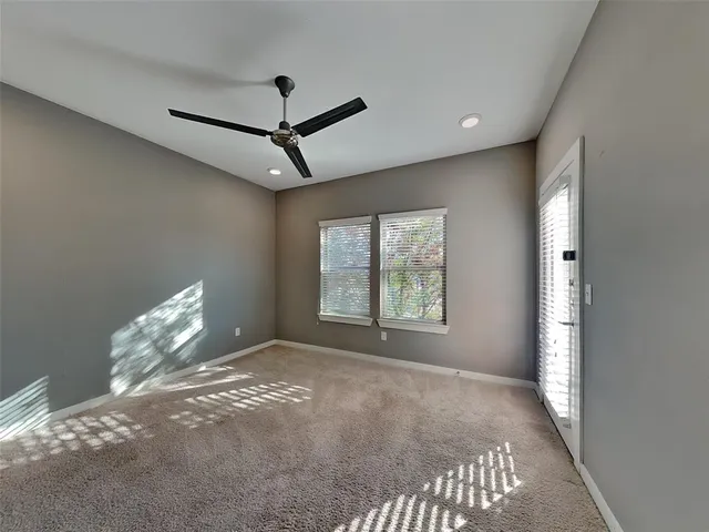 a view of a livingroom with a ceiling fan and window