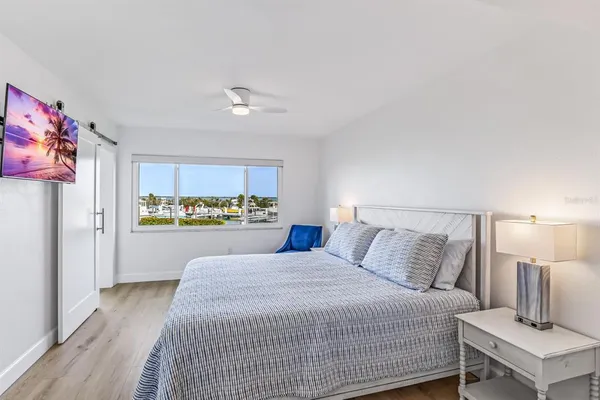 a bedroom with a bed and a view of kitchen