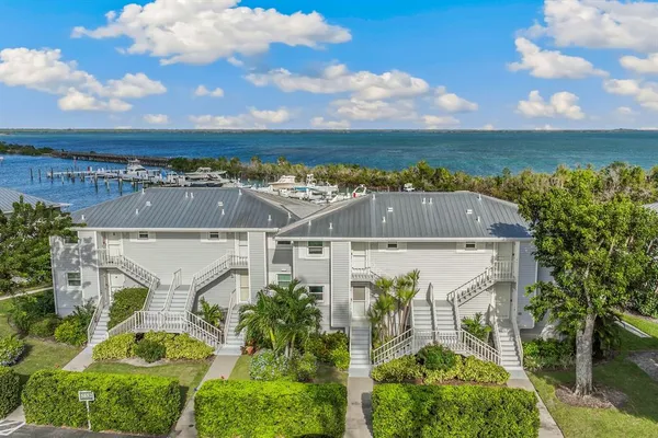 an aerial view of a house with a ocean view and mountain view