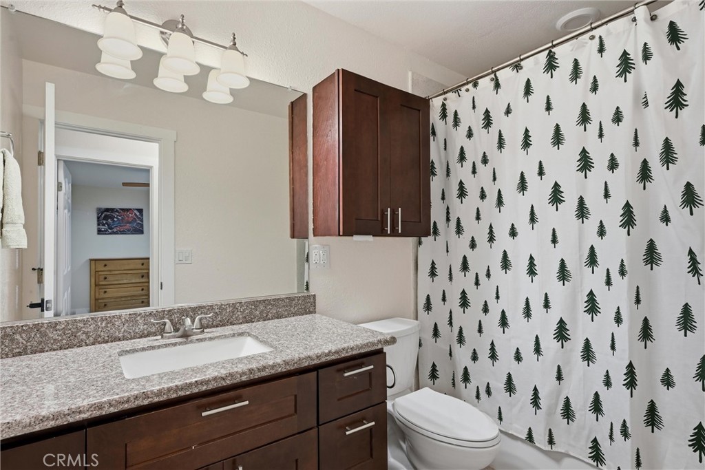 16906 Greenridge Road Hidden Valley Lake, CA 95467 - Photo 11 of 24 a bathroom with a granite countertop sink toilet and shower