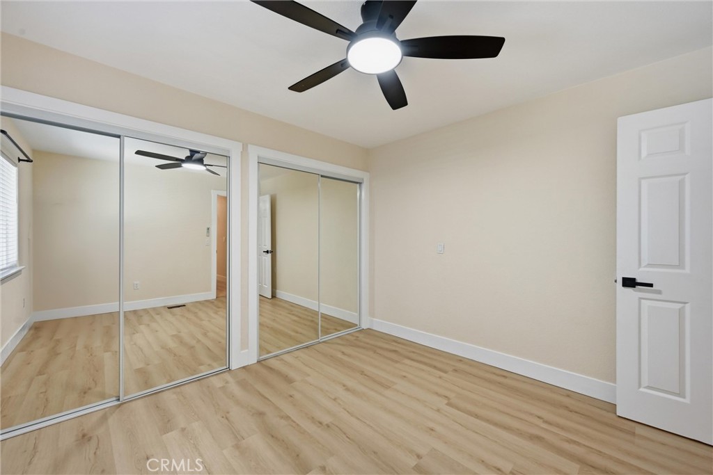 16906 Greenridge Road Hidden Valley Lake, CA 95467 - Photo 14 of 24 an empty room with wooden floor closet and windows