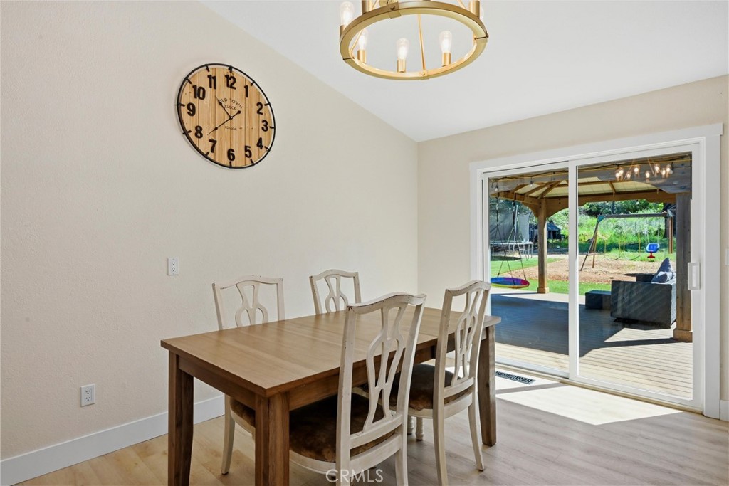 16906 Greenridge Road Hidden Valley Lake, CA 95467 - Photo 5 of 24 a view of a room that has a table and a chair in it