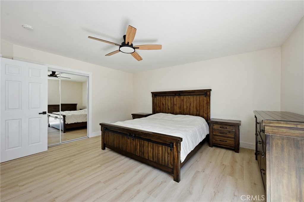 16906 Greenridge Road Hidden Valley Lake, CA 95467 - Photo 7 of 24 a bedroom with a bed and a chandelier
