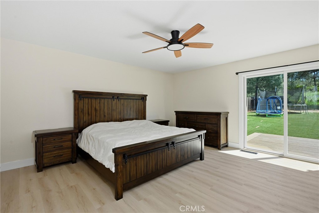 16906 Greenridge Road Hidden Valley Lake, CA 95467 - Photo 8 of 24 a spacious bedroom with a bed and large window