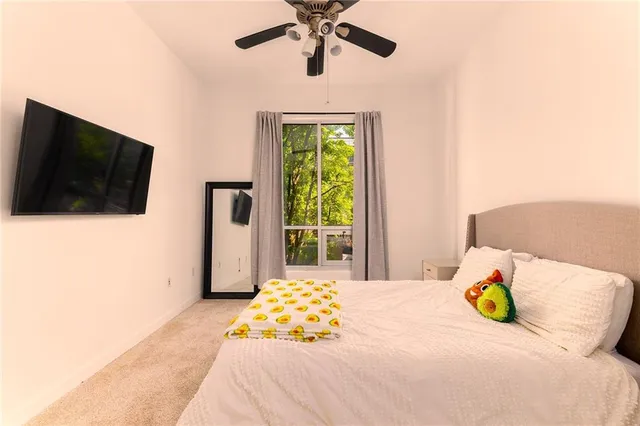 a bedroom with a bed and a flat screen tv