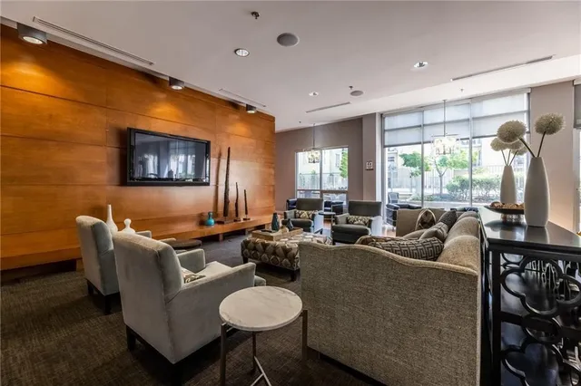 a living room with fireplace furniture and a large window