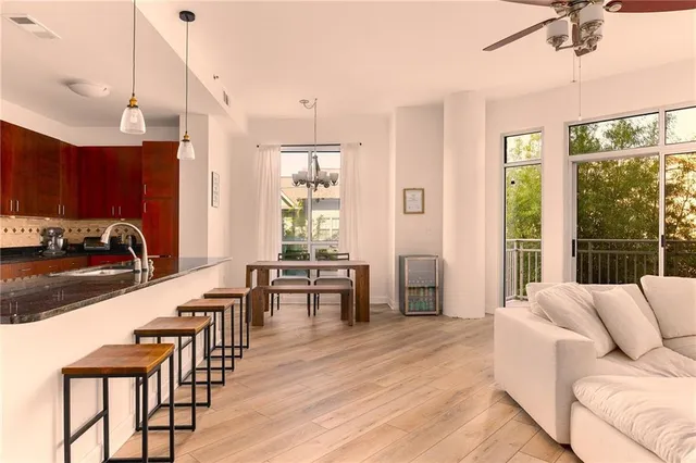 a living room with furniture a wooden floor and a window