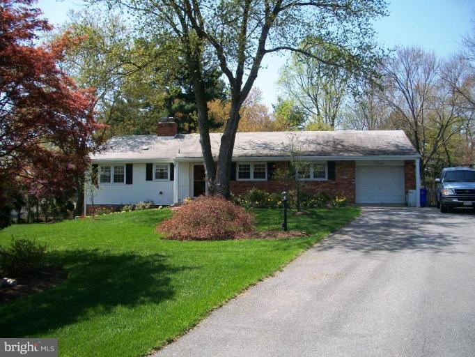 14608 Sturtevant Road Silver Spring, MD 20905 - Photo 1 of 27 a front view of a house with a yard and large trees