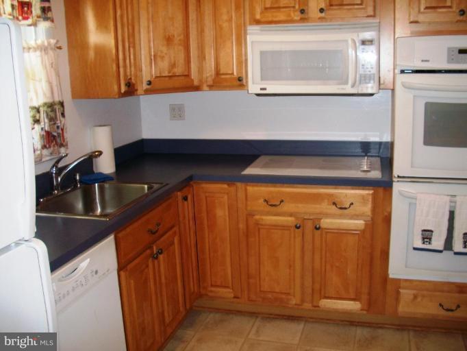 14608 Sturtevant Road Silver Spring, MD 20905 - Photo 2 of 27 a kitchen with a sink cabinets and a window