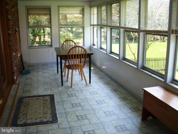 14608 Sturtevant Road Silver Spring, MD 20905 - Photo 14 of 27 a dining room with furniture and large windows