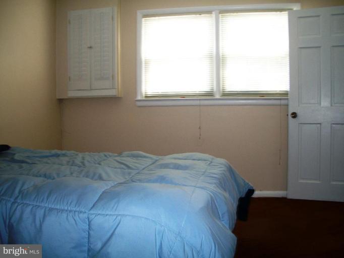 14608 Sturtevant Road Silver Spring, MD 20905 - Photo 18 of 27 a bed sitting in a bedroom next to a window