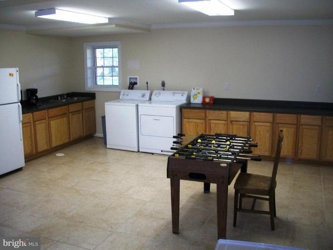 14608 Sturtevant Road Silver Spring, MD 20905 - Photo 22 of 27 a kitchen with a table chairs and a stove