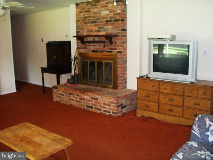 14608 Sturtevant Road Silver Spring, MD 20905 - Photo 24 of 27 a living room with furniture and a flat screen tv