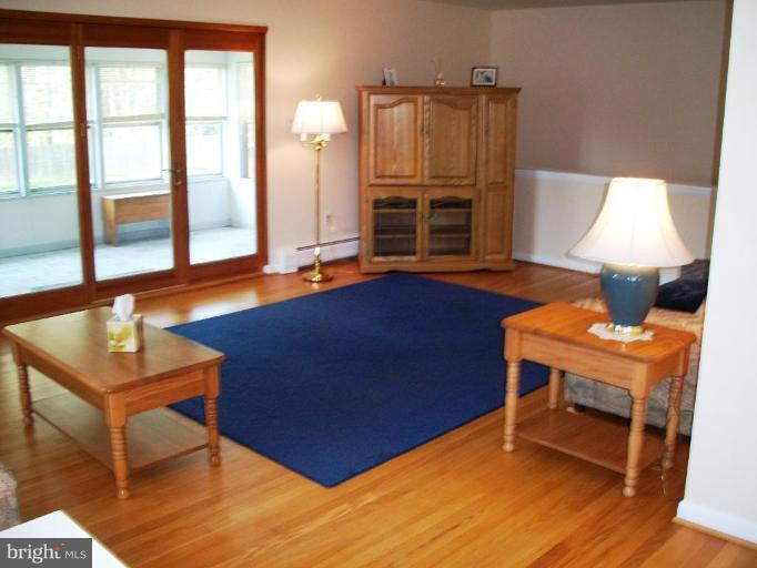 14608 Sturtevant Road Silver Spring, MD 20905 - Photo 5 of 27 a view of a room with furniture and wooden floor