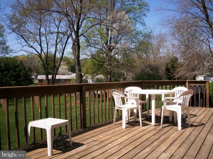 14608 Sturtevant Road Silver Spring, MD 20905 - Photo 8 of 27 a view of a chairs on wooden deck