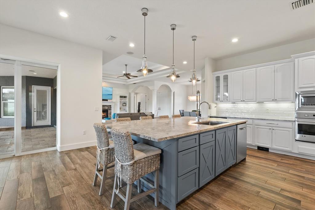 6816 Hawkins Road Sarasota, FL 34241 - Photo 12 of 60 a kitchen with stainless steel appliances granite countertop a kitchen island a stove a table and chairs in it