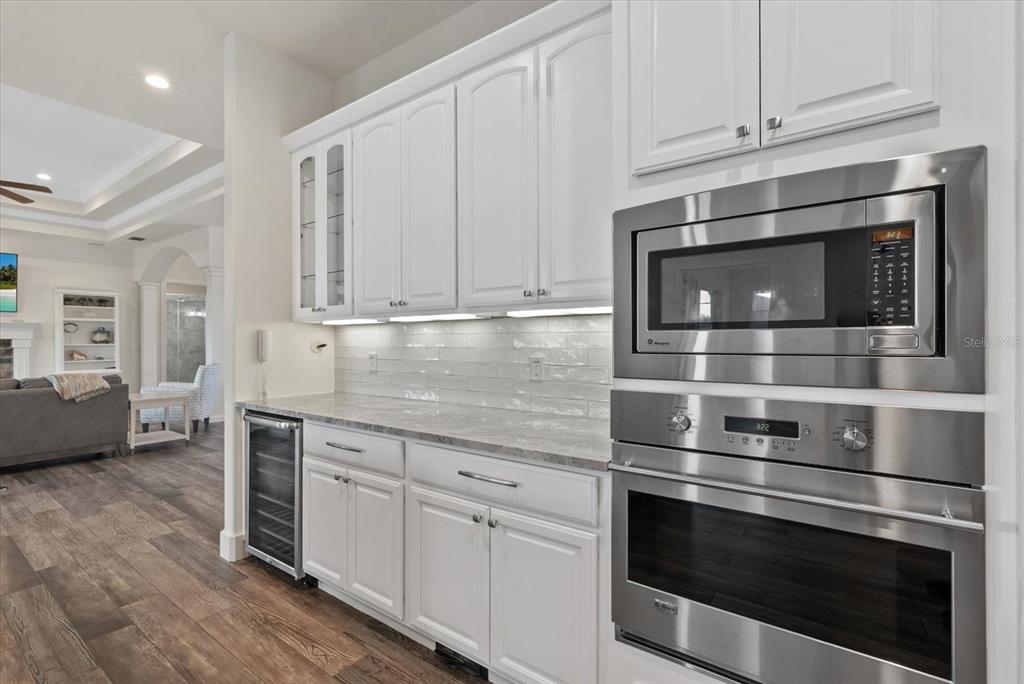 6816 Hawkins Road Sarasota, FL 34241 - Photo 15 of 60 a kitchen with granite countertop white cabinets and stainless steel appliances