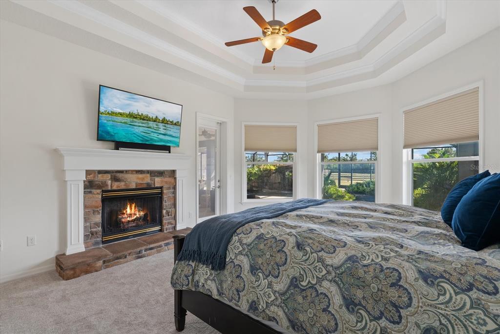 6816 Hawkins Road Sarasota, FL 34241 - Photo 18 of 60 a bedroom with a bed and a fireplace