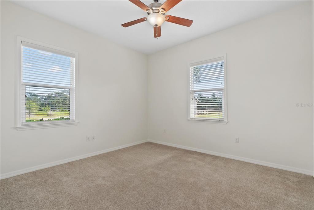 6816 Hawkins Road Sarasota, FL 34241 - Photo 23 of 60 an empty room with a window and a fan