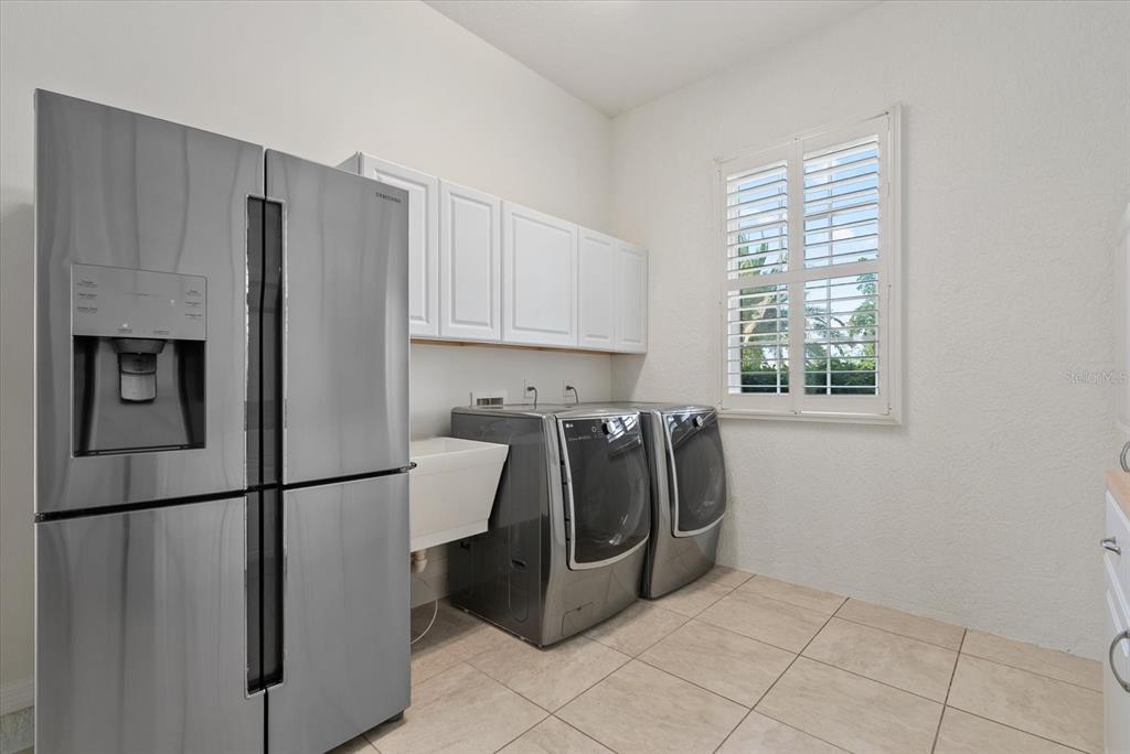 6816 Hawkins Road Sarasota, FL 34241 - Photo 27 of 60 a kitchen with stainless steel appliances granite countertop a refrigerator and a sink
