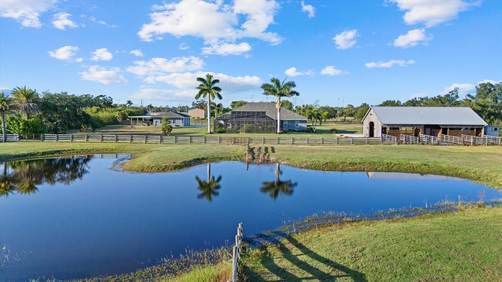 6816 Hawkins Road Sarasota, FL 34241 - Photo 51 of 60 a view of a lake with a house in the background