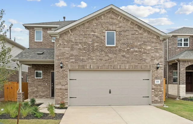 a front view of a house with garage
