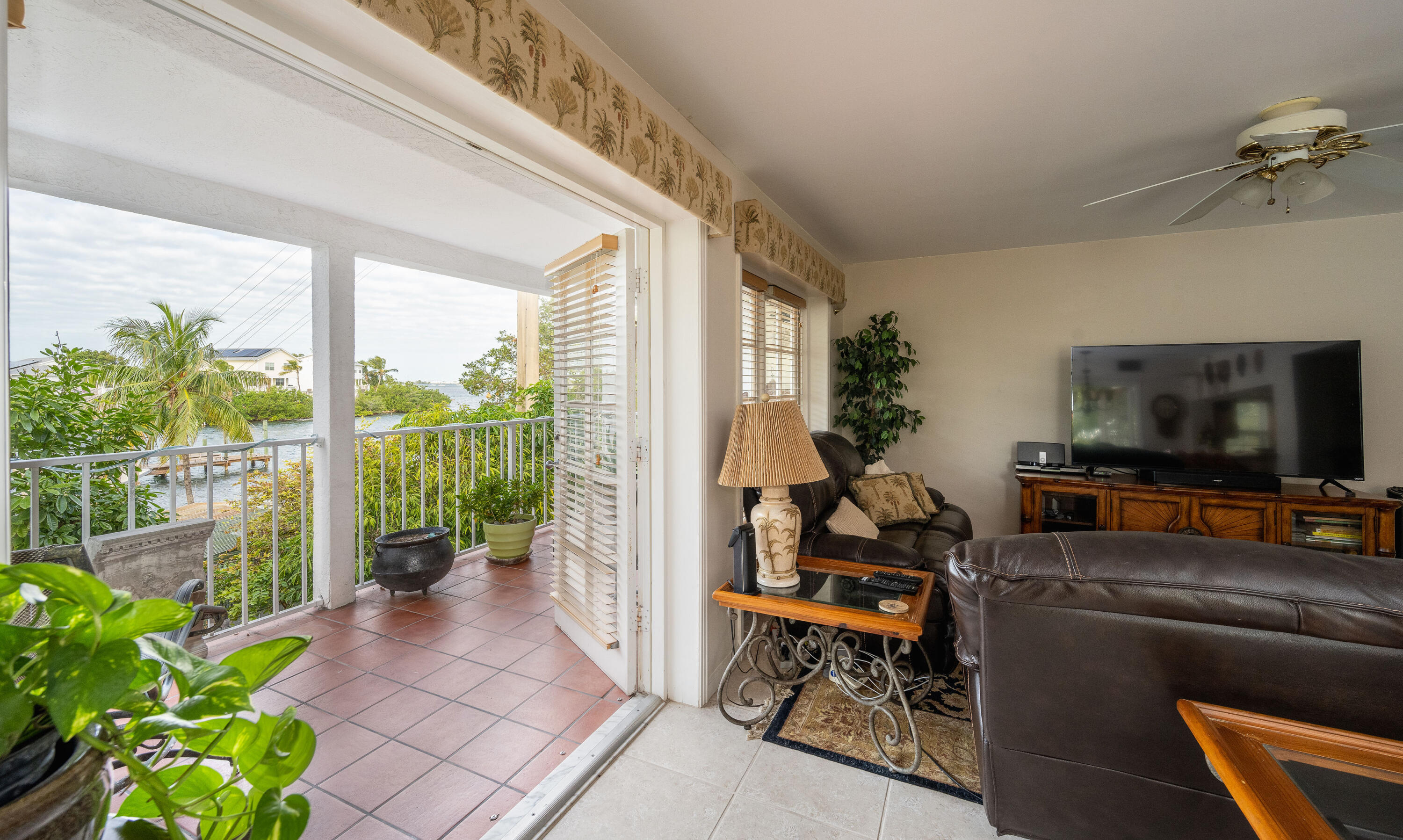 30 Hilton Haven Road, Unit 2A Key West, FL 33040 - Photo 11 of 42 a living room with patio furniture and a flat screen tv