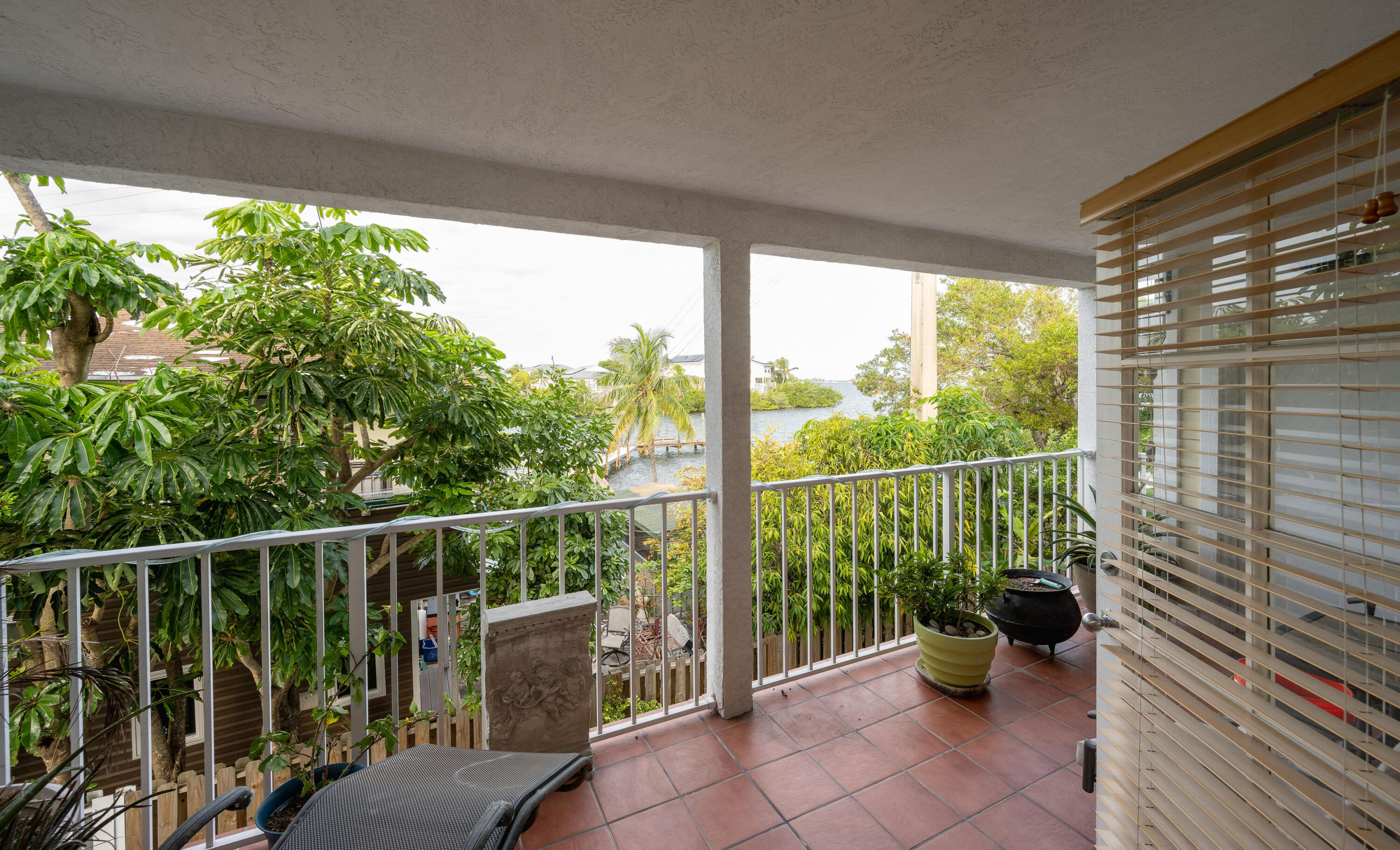 30 Hilton Haven Road, Unit 2A Key West, FL 33040 - Photo 12 of 42 a view of a balcony with chair potted plant