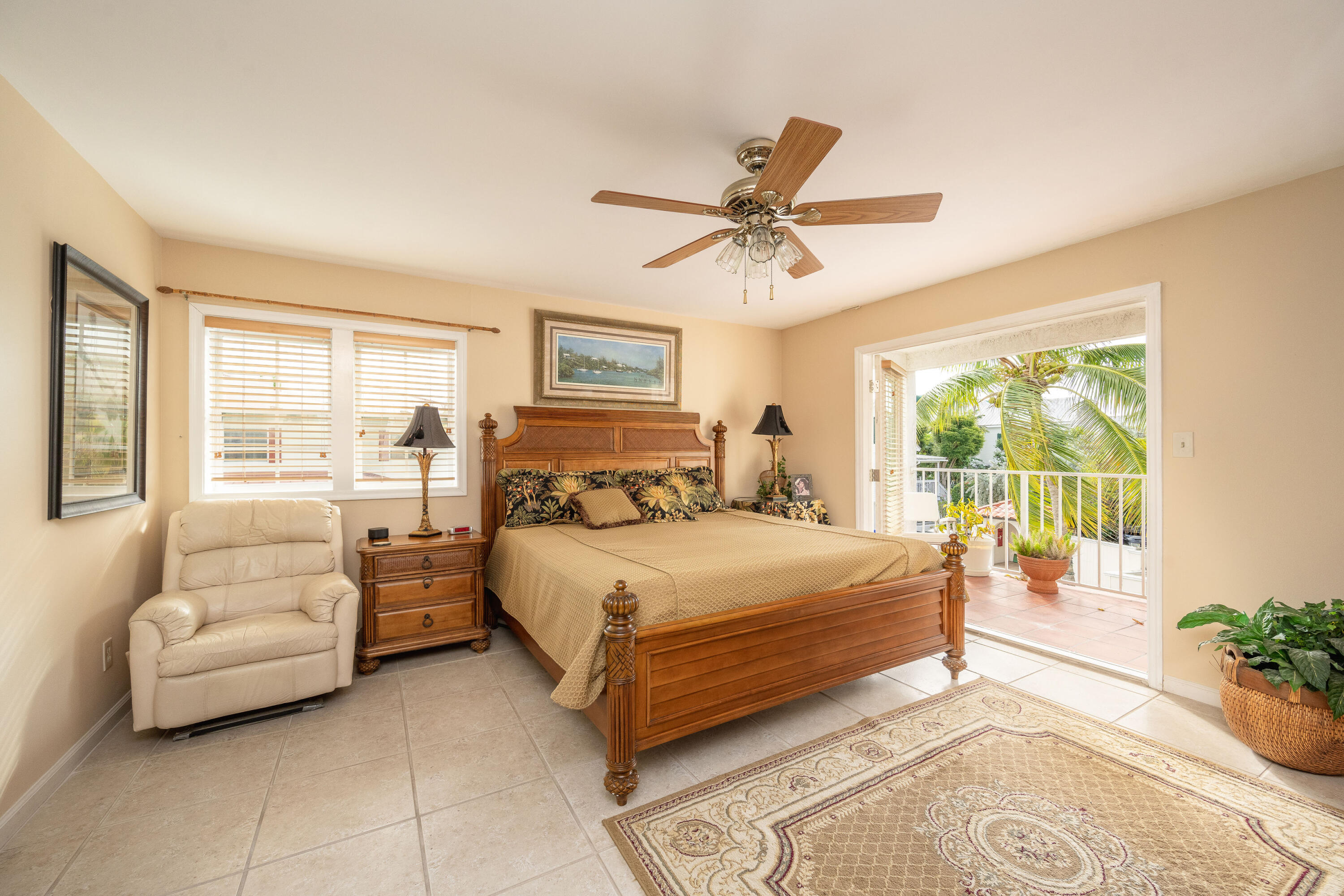 30 Hilton Haven Road, Unit 2A Key West, FL 33040 - Photo 23 of 42 a bedroom with a bed couch and large windows