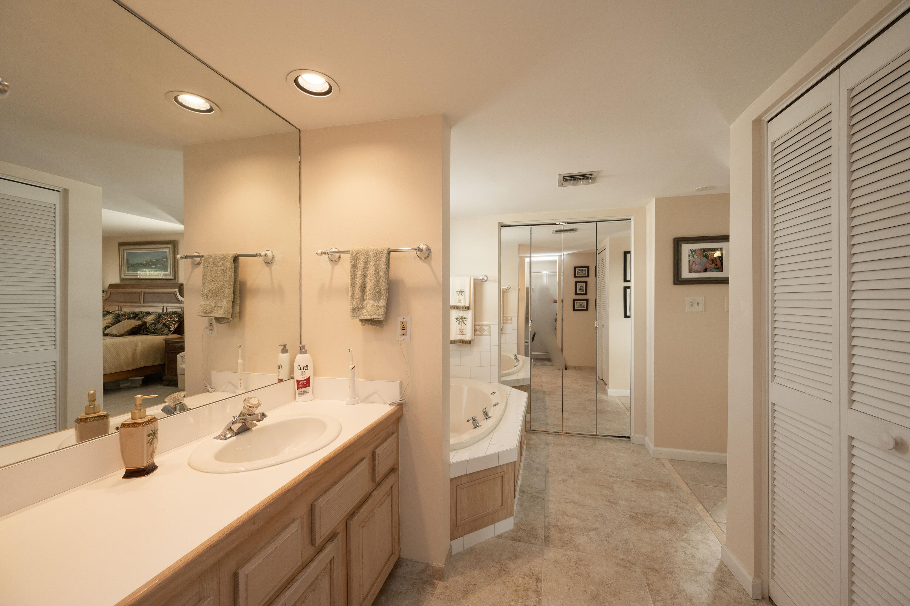 30 Hilton Haven Road, Unit 2A Key West, FL 33040 - Photo 30 of 42 a bathroom with a double vanity sink mirror double shower and toilet