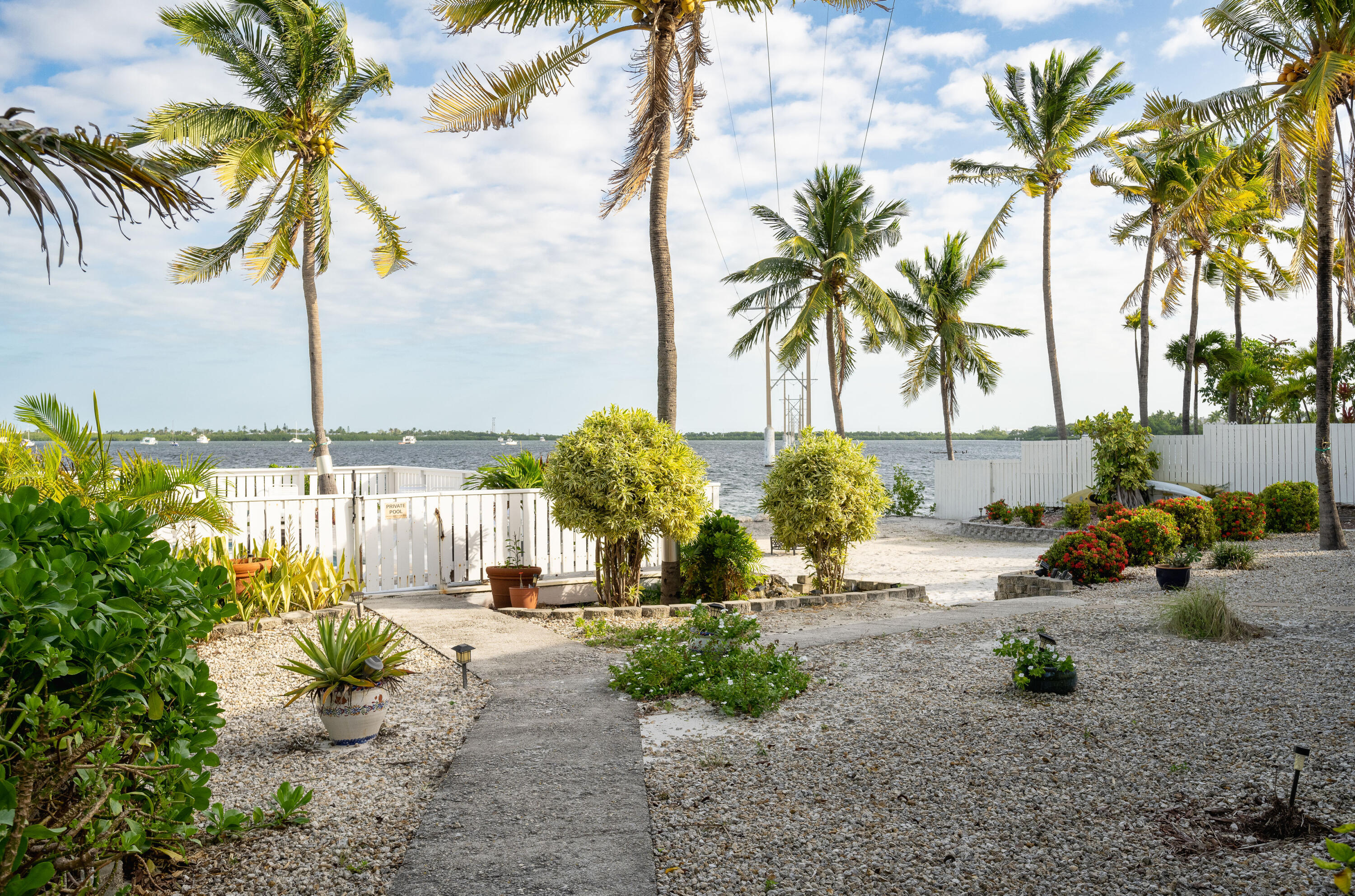 30 Hilton Haven Road, Unit 2A Key West, FL 33040 - Photo 31 of 42 a row of palm trees and a fire pit