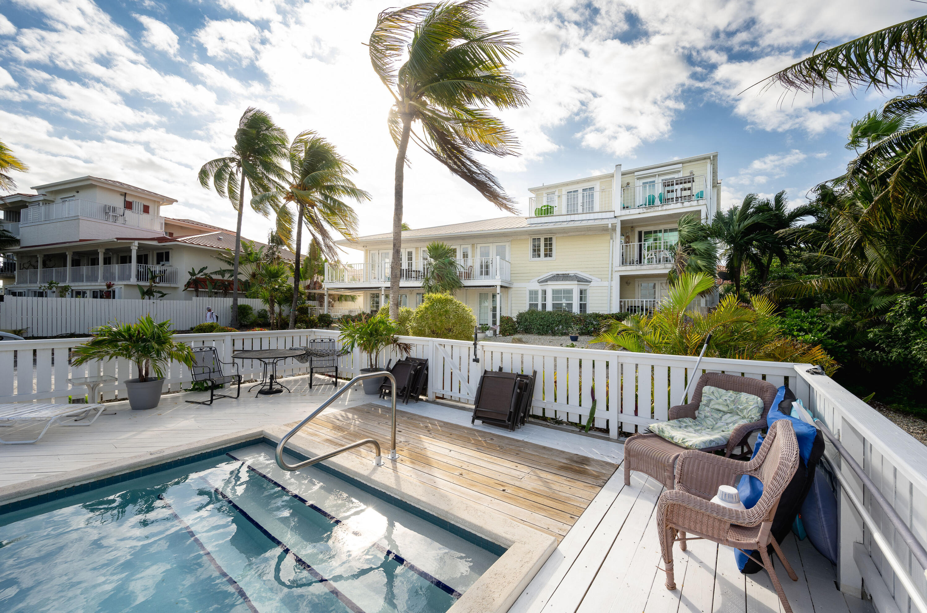 30 Hilton Haven Road, Unit 2A Key West, FL 33040 - Photo 36 of 42 a view of a patio with couches table and chairs and potted plants