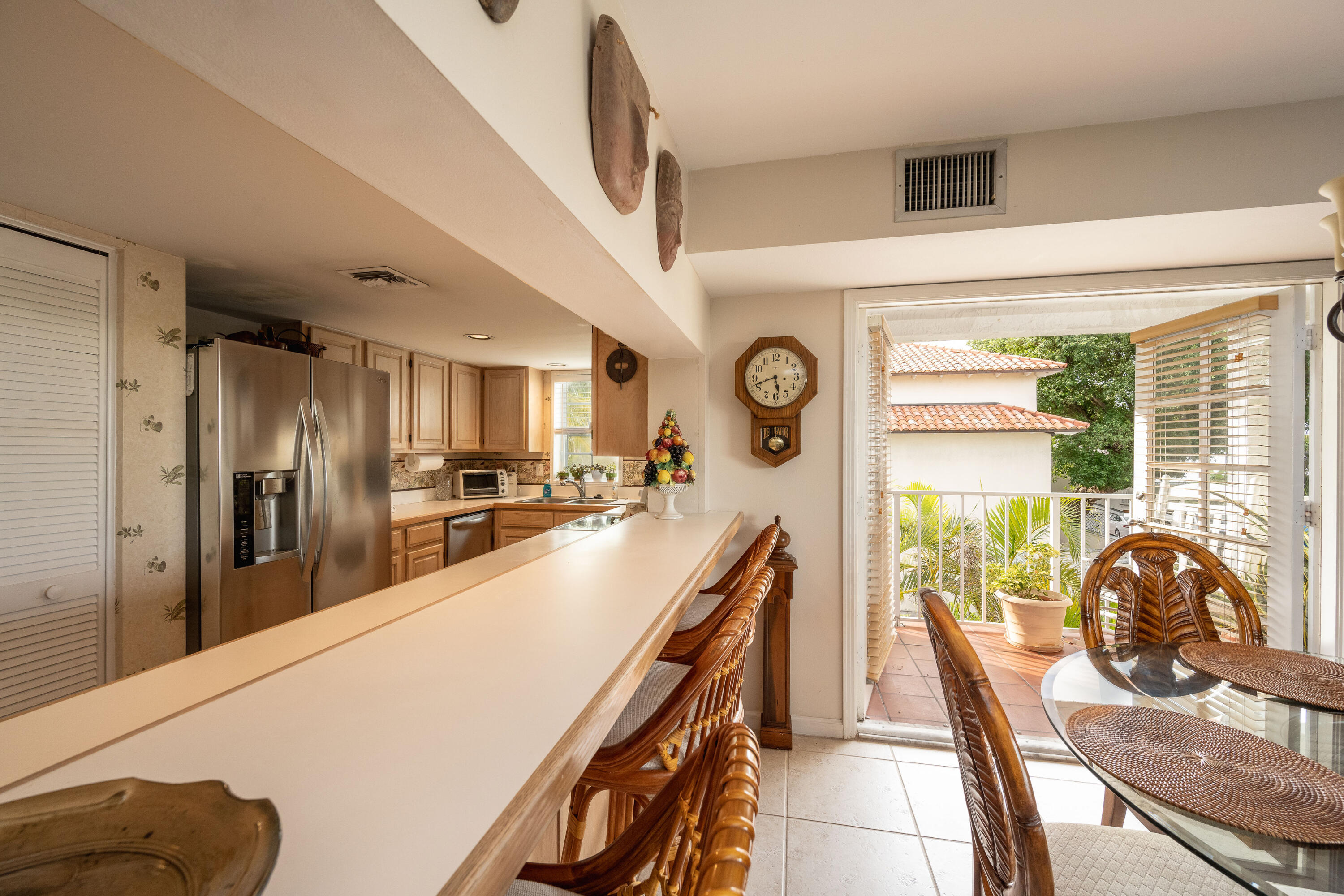 30 Hilton Haven Road, Unit 2A Key West, FL 33040 - Photo 6 of 42 a view of a kitchen with kitchen island a large window a sink and stainless steel appliances
