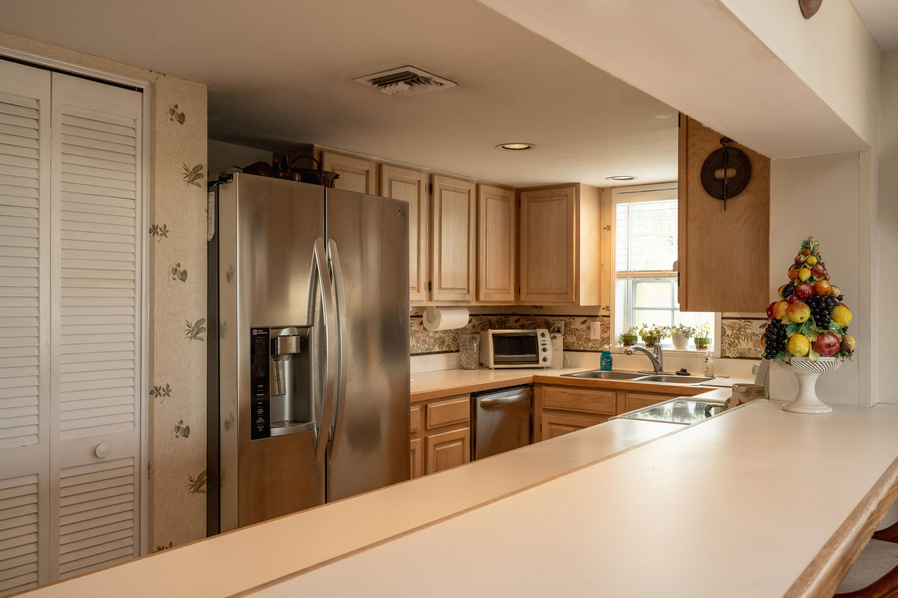 30 Hilton Haven Road, Unit 2A Key West, FL 33040 - Photo 7 of 42 a kitchen with stainless steel appliances a refrigerator sink and cabinets