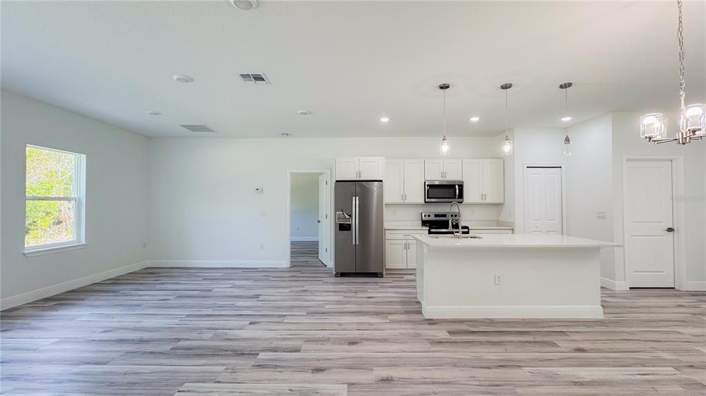 15625 Southwest 37th Circle Ocala, FL 34473 - Photo 6 of 27 a view of kitchen with stainless steel appliances refrigerator stove microwave and cabinets