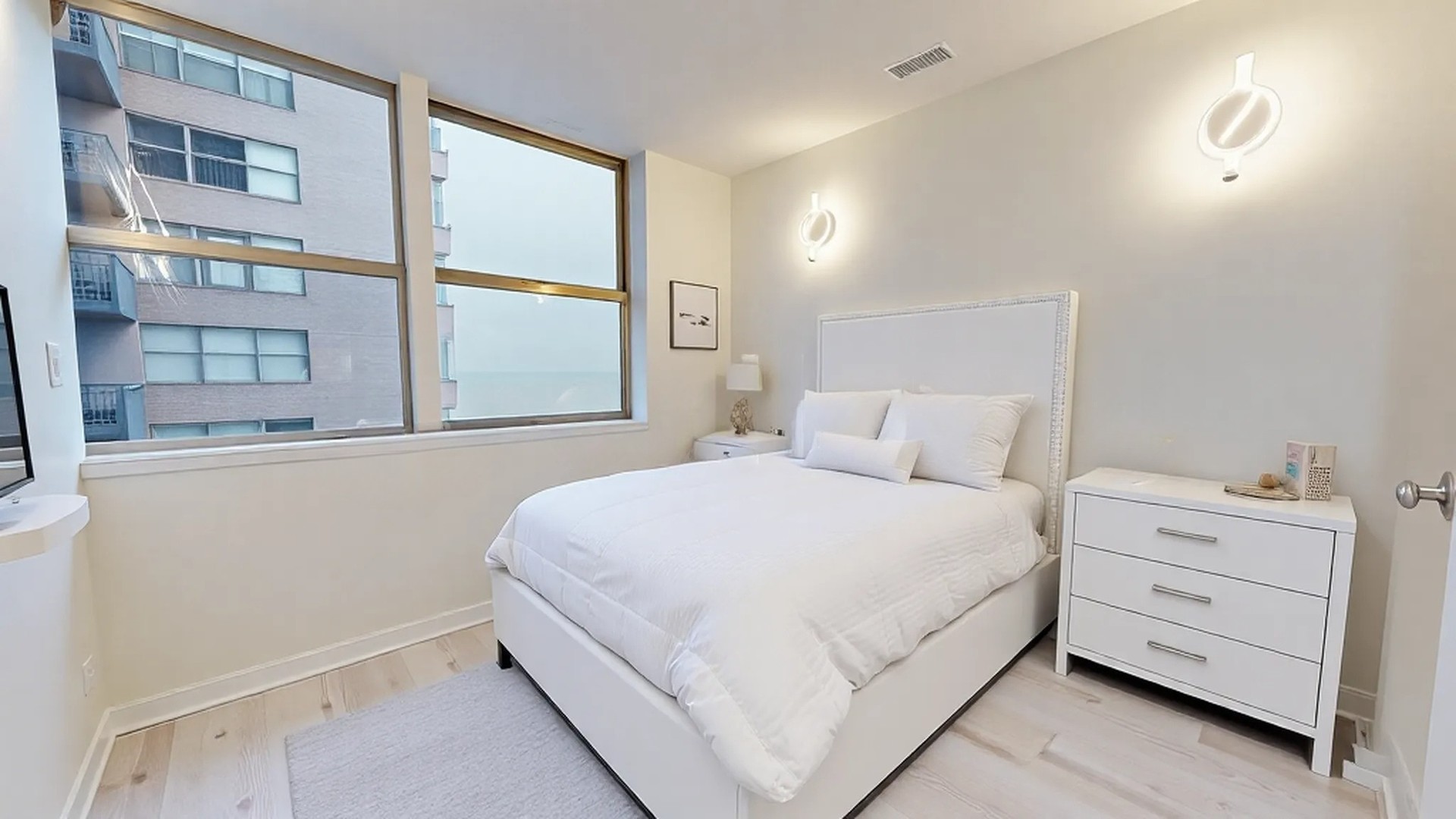 6301 North Sheridan Road, Unit 17G Chicago, IL 60660 - Photo 11 of 14 a bedroom with a bed and a window