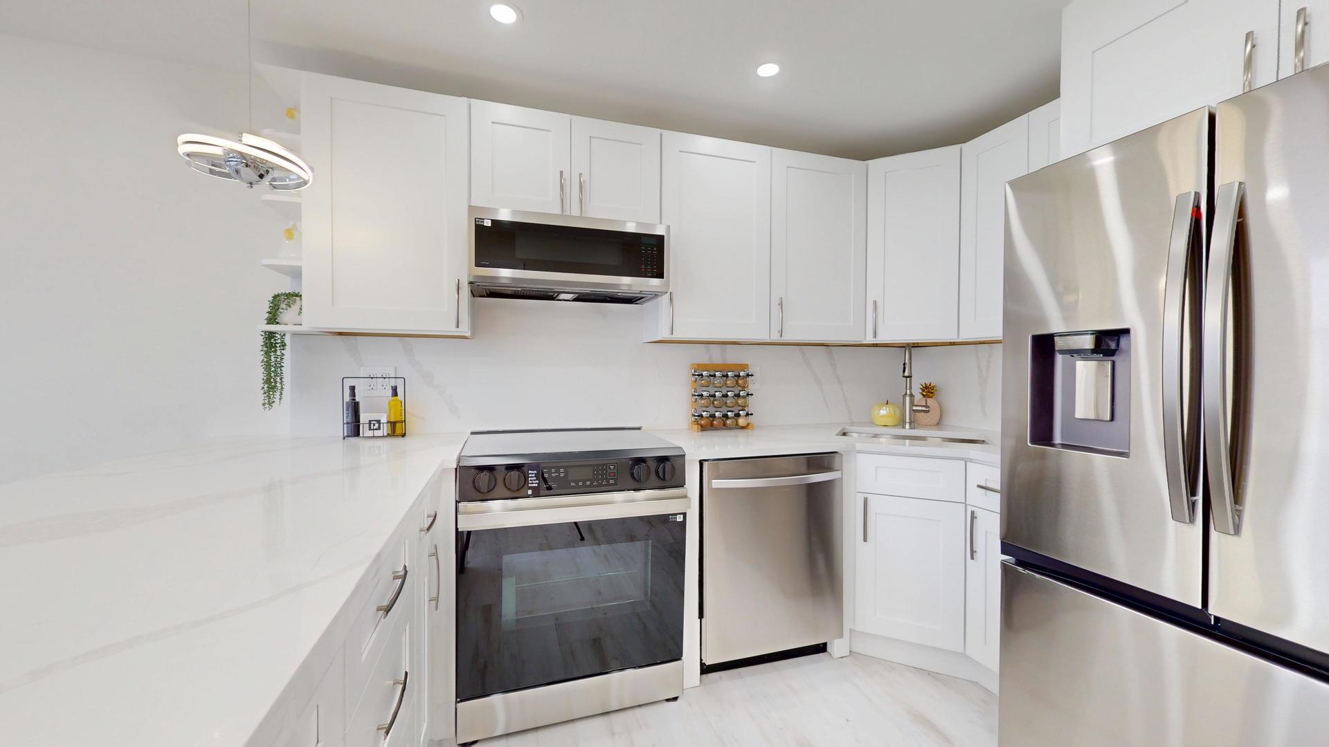 6301 North Sheridan Road, Unit 17G Chicago, IL 60660 - Photo 9 of 14 a kitchen with stainless steel appliances white cabinets and a refrigerator