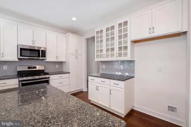 a kitchen with a stove a sink and a refrigerator