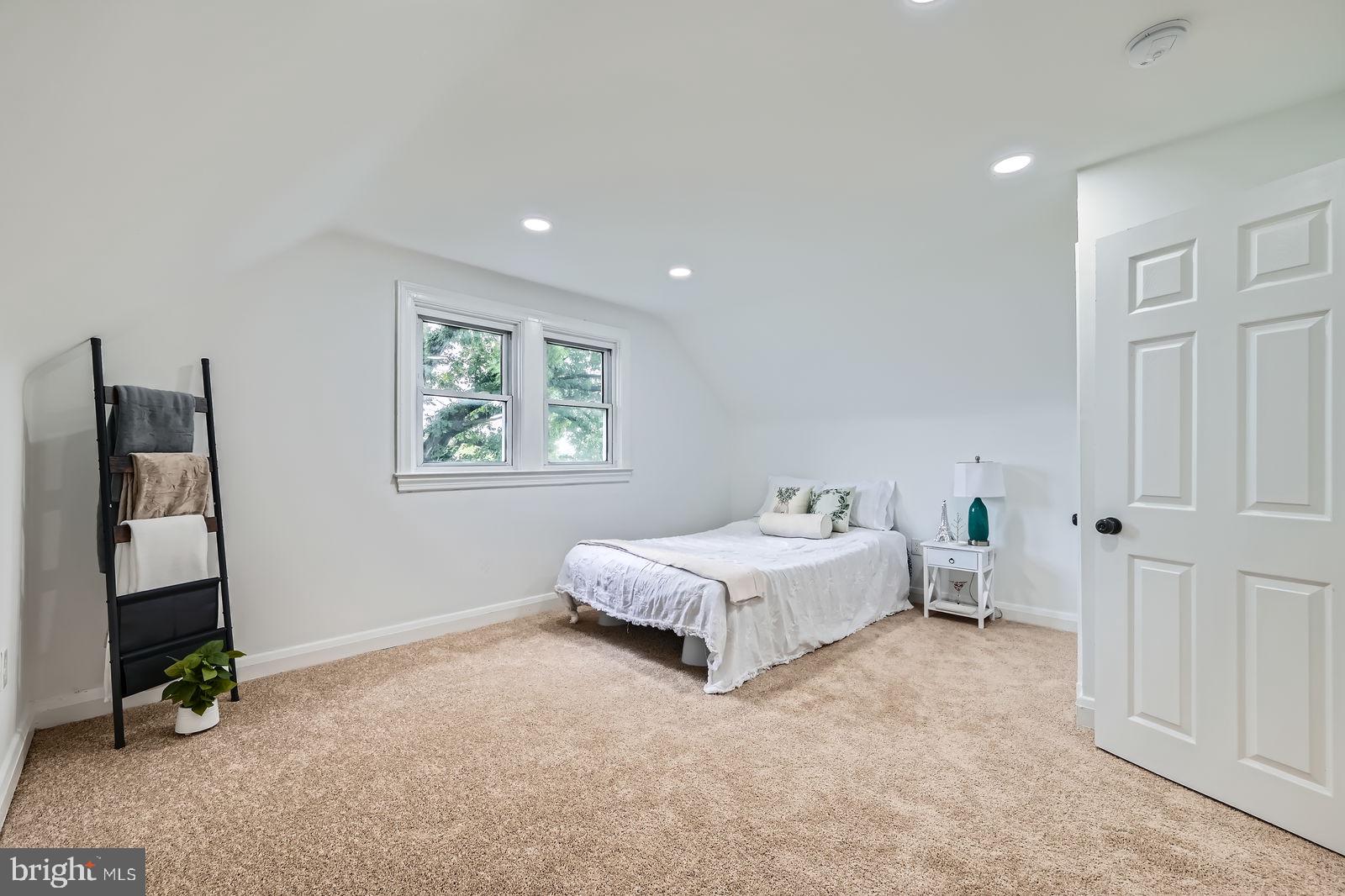3814 Cedardale Road Baltimore, MD 21215 - Photo 17 of 28 a spacious bedroom with a bed and a window