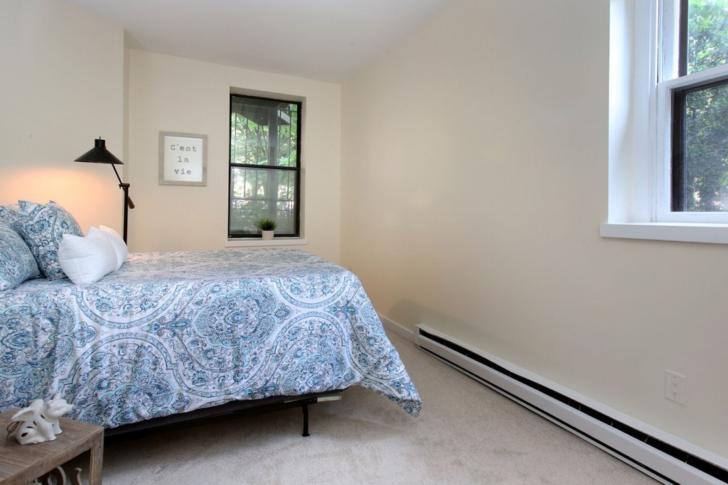 75 Waltham Street, Unit 2 Boston, MA 02118 - Photo 5 of 8 a bedroom with a bed and window