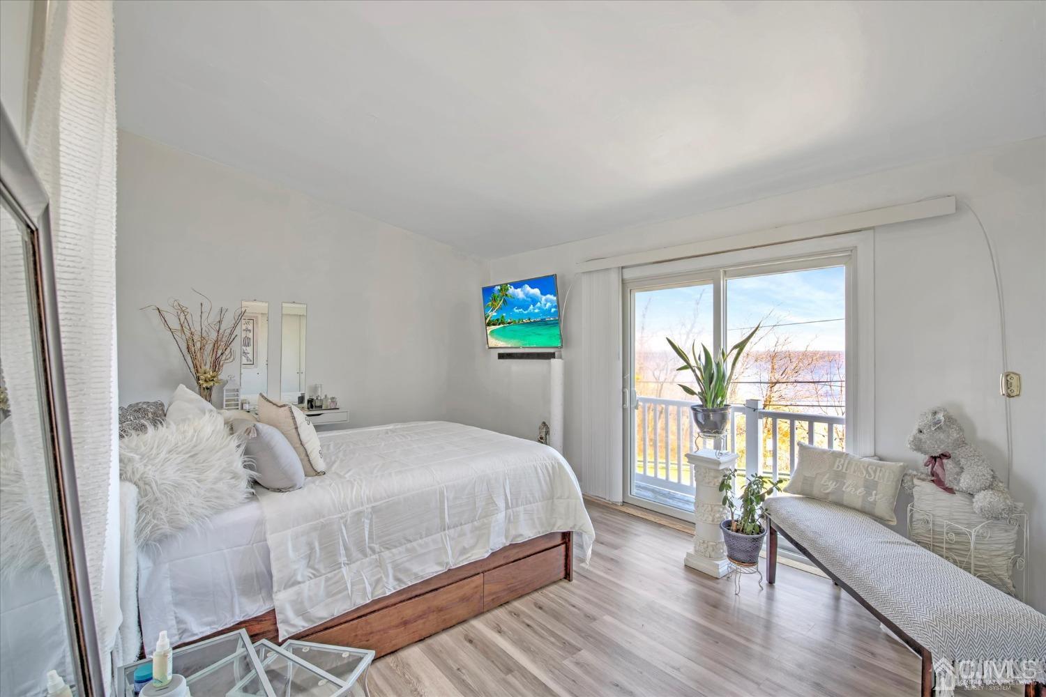 315 Beach Drive Keyport, NJ 07735 - Photo 28 of 40 a bedroom with a bed and wooden floor