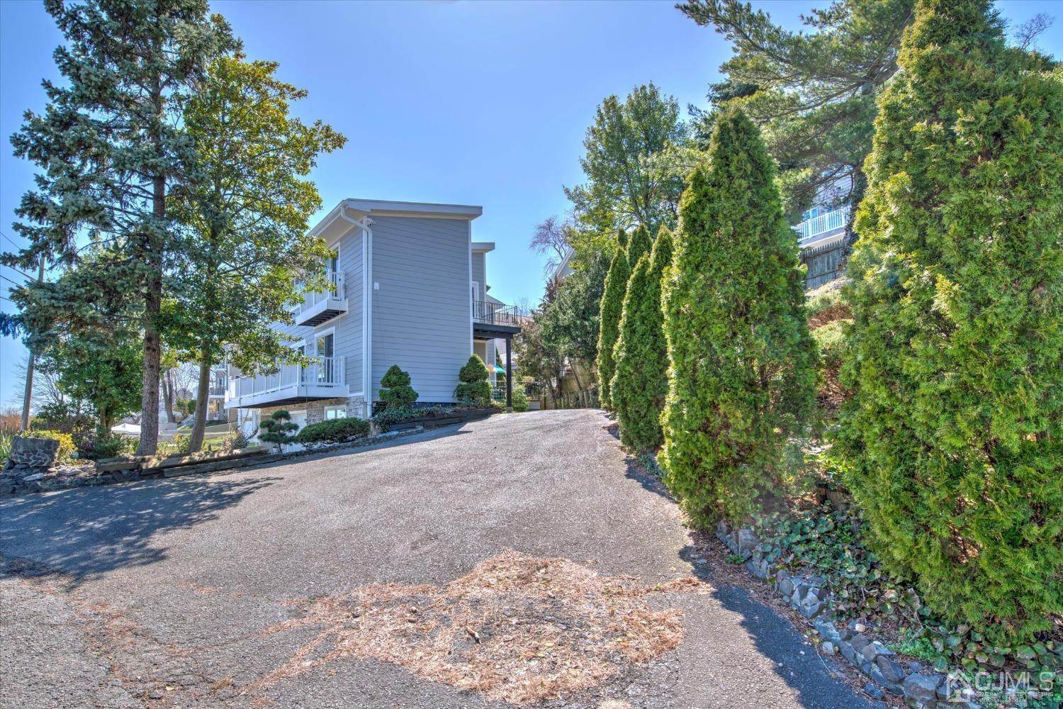 315 Beach Drive Keyport, NJ 07735 - Photo 3 of 40 a pathway of a house with potted plants and large trees