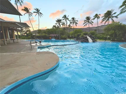 a view of a swimming pool with a yard