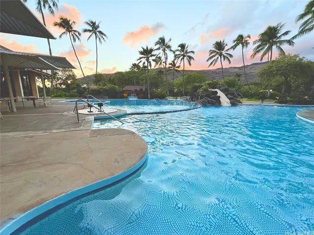 a view of a swimming pool with a yard