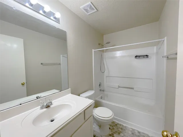 a bathroom with a sink mirror toilet and bathtub