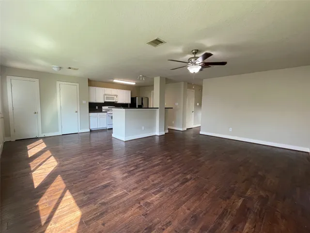 a view of a kitchen with a stove cabinets and wooden floor