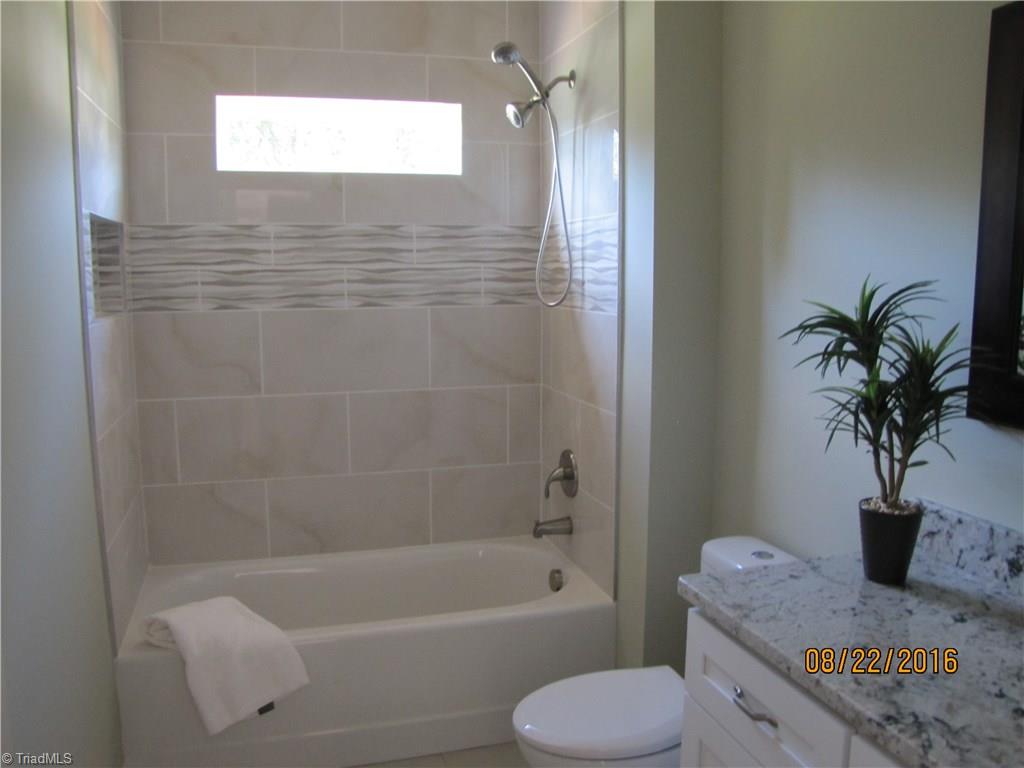 3609 Ruby Road Winston-Salem, NC 27106 - Photo 16 of 27 Hall Bathroom. Granite top vanity & tiled surround shower/tub.